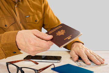 Wall Mural - Traveling businessman handing his international passport for customs control, inscription European Union French Republic passport, on a light gray studio background