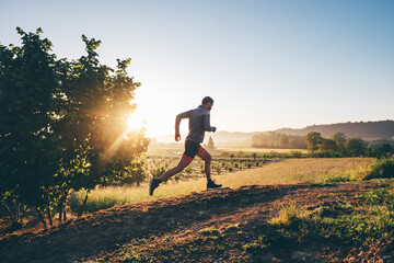 Man running in the countryside at sunrise