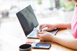 © Witoon - Close-up shot of hand holding credit card and using laptop Businesswoman or entrepreneur working from home online shopping, ecommerce, internet banking, take money, work from home concepts