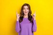 © deagreez - Photo of young funky excited lady wear purple jumper fingers pointing up empty space new brand season sale isolated on yellow color background