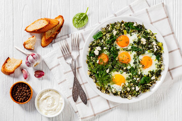 Canvas Print - green shakshuka on white plate, top view