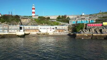 Aerial View Of Plymouth Hoe Seafront Terrace, Wild Swimming From The Beach And Smeaton's Tower Lighthouse, Plymouth, UK.
