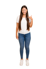 Wall Mural - Young asian woman standing, full body cutout isolated person pointing by hand to a shirt copy space, proud and confident