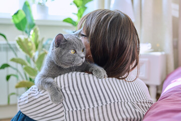 Wall Mural - Gray pet cat in the hands of woman owner
