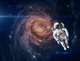 Fototapeta Kosmos - Astronaut and alien spiral galaxy. This image elements furnished by NASA.