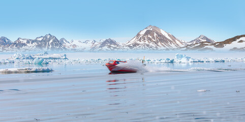Wall Mural - fast moving motorboat trying to get out of the ice - stranded icebergs in the fog at the mouth of th