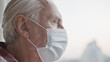 © Synthex - Close-up of elderly man in face mask, high-risk demographic group amid covid-19 pandemic