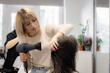 © Nataliya - The hairdresser dries the hair of a client.