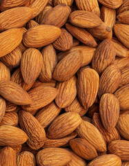 Peeled almonds background closeup. Vegetarian food concept. Raw almond nuts wallpaper.