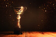 Leinwandbild Motiv image of gold trophy with sparkly overlay over dark background