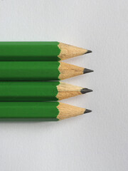 Poster - four green pencils on paper sheet