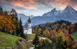 Beautiful nature landscape. Incredible autumn scenery. View on Alpine highlands with Watzmann mount, colorful trees and Small church. Famous Maria Gern Church. Berchtesgaden Bavaria Alps Germany