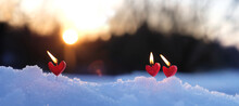 Red Candles Heart On Snow, Abstract Blurred Natural Background. Beautiful Winter Landscape With Burning Romantic Candles. Symbol Of Love, Romance, Happiness, Valentine's Day. Witch Ritual For Lovers.