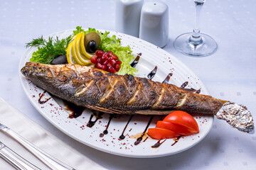Wall Mural - Fried sea bass on grill on white plate