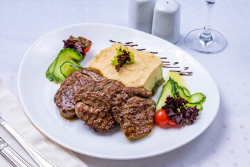 Wall Mural - medallions of beef with mashed potatoes on white table