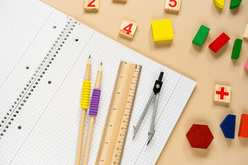 Wall Mural - Set of supplies for mathematics and for school. Fractions, rulers, pencils, notepad on beige background. Back to school, fun education concept. School supplies on the table