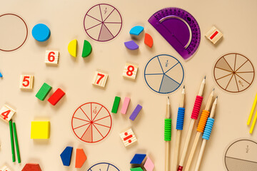Wall Mural - Set of supplies for mathematics and for school. Fractions, rulers, pencils, notepad on beige background. Back to school, fun education concept