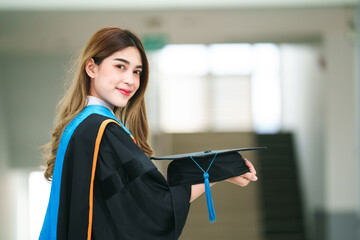 Wall Mural - Graduates wear a black dress, black hat at the university level.