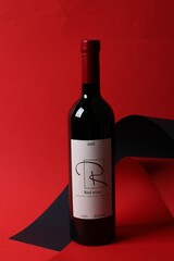 Wall Mural - Bottle of delicious red wine on color background