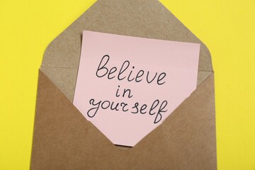 Wall Mural - Envelope with message Believe In Yourself on yellow background, top view. Motivational quote