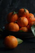 © Berna Şafoğlu - Group of tangerines on a black background