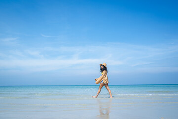 Wall Mural - Happy carefree woman enjoying beautiful sea on the beach,Summer holidays concept.