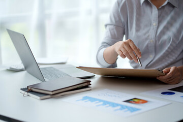 Wall Mural - Businesswoman pointing at expense chart Budget management, income tax, financial statements, budgets, important financial document.