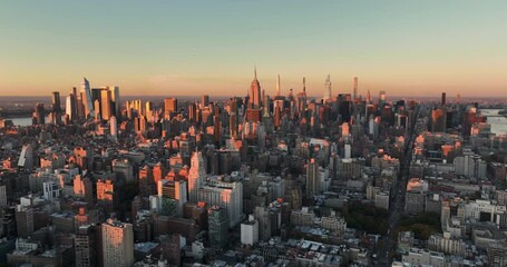 Wall Mural - Flying backwards above Manhattan buildings, New York City at sunset. City panorama