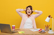 © ViDi Studio - Young employee business woman in casual shirt sit work at office desk with pc laptop cover ear with hand fingers do not want to listen scream isolated on plain yellow color background Career concept