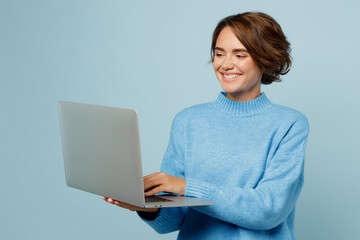 young smiling happy fun caucasian smart it woman wear knitted sweater hold use work on laptop pc com