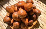 heap of salak fruit or salacca on bamboo table.