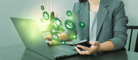 ESG environment social governance investment business concept. Women use a computer to analyze ESG, surrounded by ESG icons .close to the computer screen in business investment strategy concept.