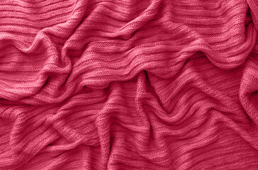 Wall Mural - Texture of smooth knitted sweater with pattern. Handmade knitting wool or cotton fabric texture. Background of Large knit pattern with knitting needle or crochet. Color Of The Year 2023 - Viva Magenta