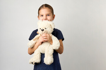 Wall Mural - Portrait of little girl with white toy bear