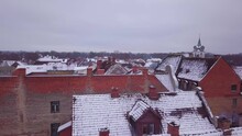 Aerial View Of Kuldiga Old Town (UNESCO Heritage) With Red Roof Tiles Covered By Snow, Overcast Winter Day, Wide Drone Shot Moving Forward