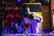 © Wavebreak Media - Smiling african american barman preparing pink cocktail at a bar