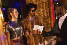 Happy, Diverse Couple And Doorman Greeting And Passing Invite At A Nightclub Entrance