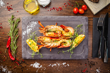 Wall Mural - Lobster with flavored butter. Herb butter, lemon. Delicious healthy traditional food closeup served for lunch in modern gourmet cuisine restaurant