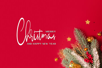 Wall Mural - Christmas decoration and pine tree on red background with copy space. New Year greeting card. Flat lay