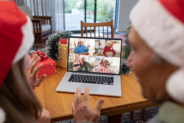 Poster - Caucasian father and daughter having christmas video call with diverse people