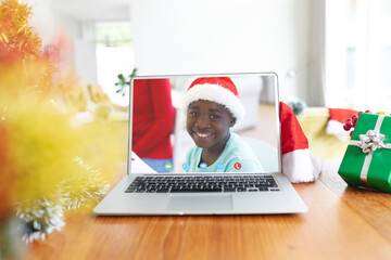Poster - African american boy having christmas video call on laptop screen