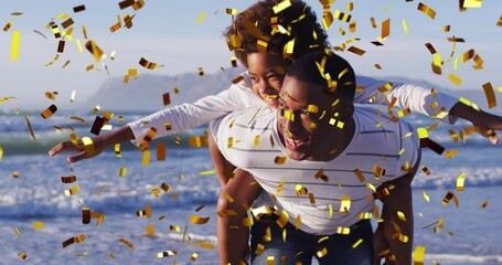 Wall Mural - Animation of christmas confetti over african american man with son on beach