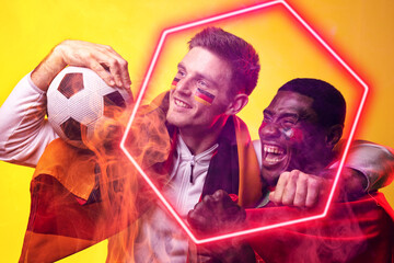 Wall Mural - Composite of multiracial cheerful male players with german flag, ball and illuminated hexagon