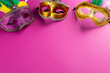 Composition of colourful mardi gras carnival masks on pink background with copy space