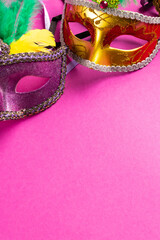 Wall Mural - composition of colourful mardi gras carnival masks on pink background with copy space