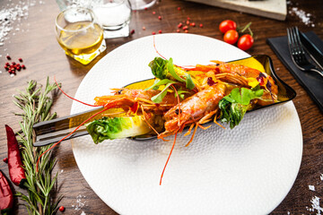 Wall Mural - Argentinian king prawns, glazed. Lime, chilly and garlic. Served in a bottle. Delicious healthy traditional food closeup served for lunch in modern gourmet cuisine restaurant