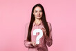 woman with question mark on pink background