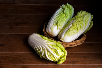 Vegetable food cabbage chinese in basket on wood table.