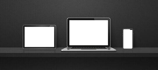 Poster - Laptop, mobile phone and digital tablet pc on black wall shelf. Banner background