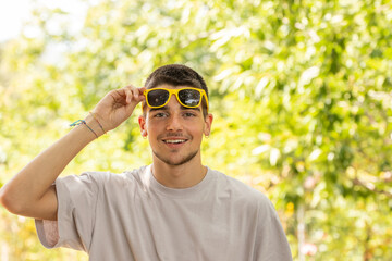 Poster - portrait of young man with sunglasses outdoors